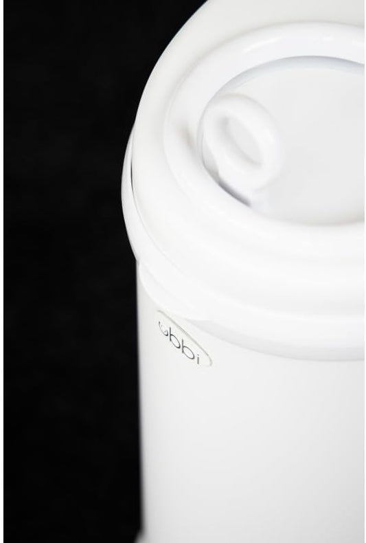 Ubbi diaper pail showing the sliding lid and childproof lock mechanism