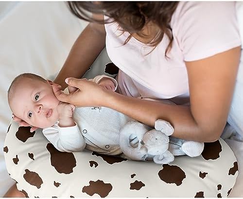 Close up of ivory and brown cow print pattern on nursing pillow slipcover