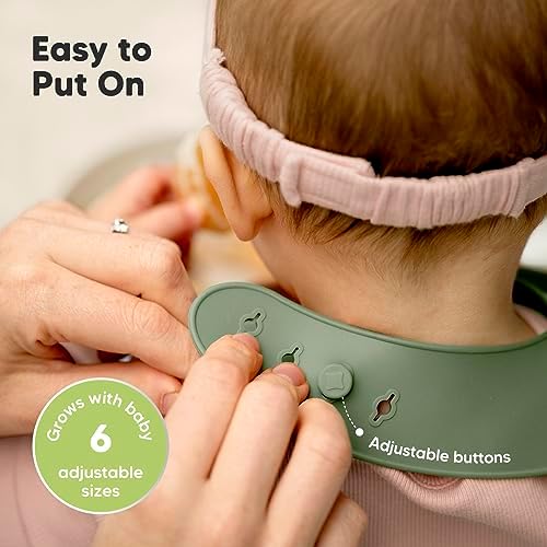 Toddler wearing KeaBabies slate silicone bib for mealtime