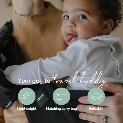 Side profile of a caregiver using the adjustable black cotton hip sling for toddler transport.