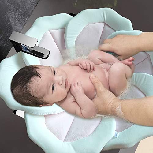 Newborn lying securely on soft Tofoan petal bath mat