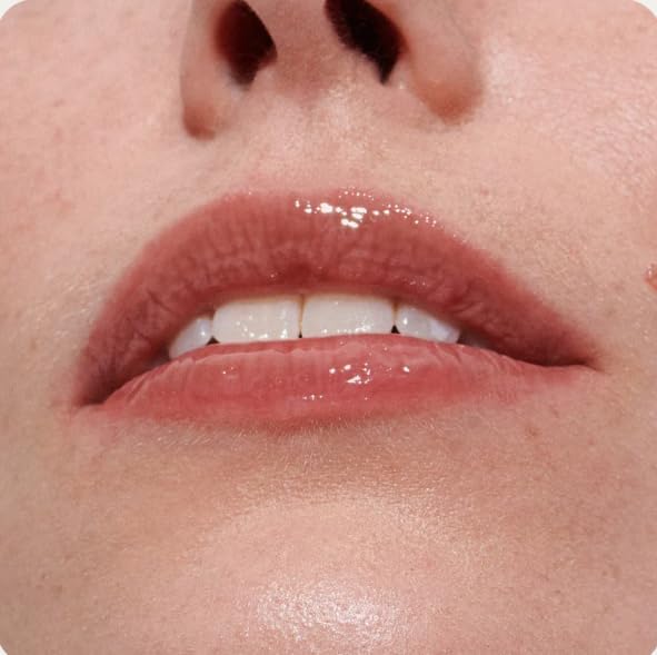 Rhode Peptide Lip Tint Toast shade tube next to its minimalist cardboard box.