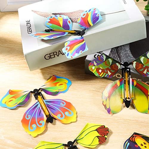 AhlsenL mechanical butterfly toy flattened inside an invitation card book marker layout
