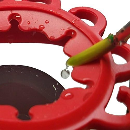 Side angle of the Paint Puck red jar with brushes resting upright in the built-in silicone holder slots