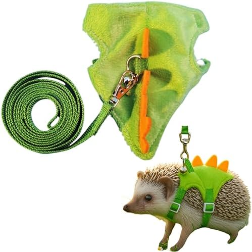 Dinosaur shaped small pet harness with orange spikes and attached safety bell on a white background