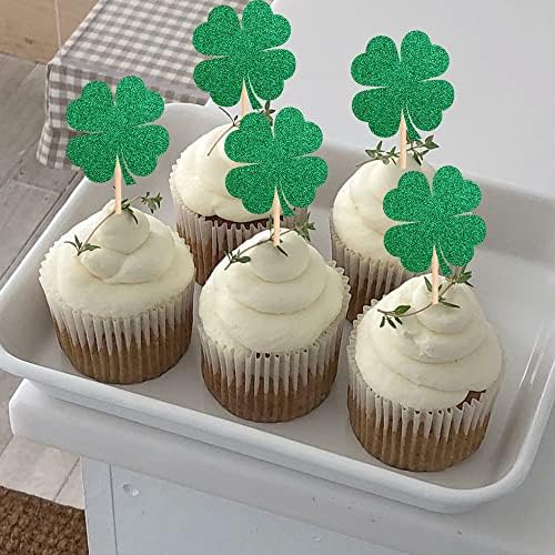 Assorted green glitter cupcake toppers on a dessert table