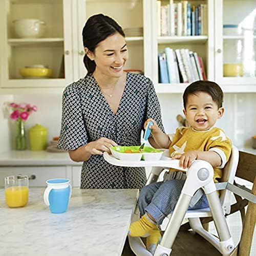 Toddler hands holding Munchkin Raise fork for self-feeding