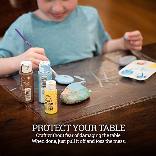 Disposable clear plastic table covers stuck to a wooden restaurant dining surface using corner adhesive