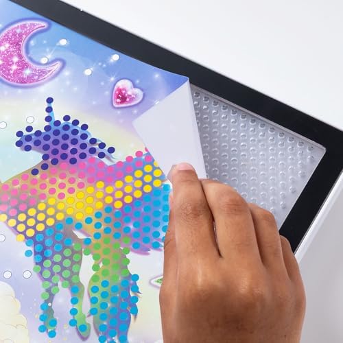 Compact travel-friendly light-up pegboard being held to show sleek portable design.