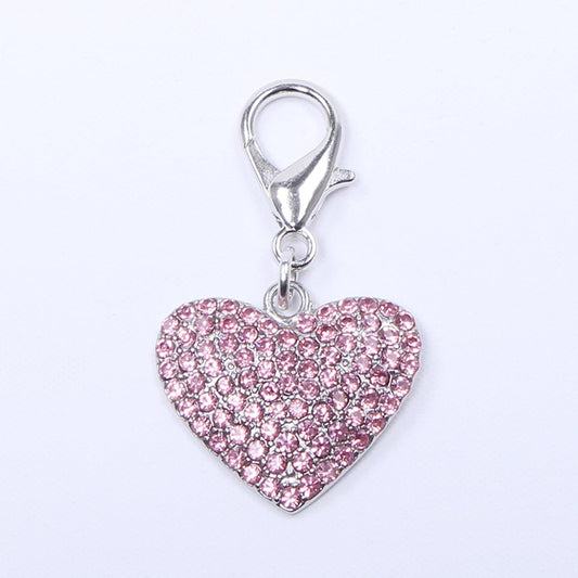 Close up of sparkling heart shaped rhinestone pet charm for small dogs