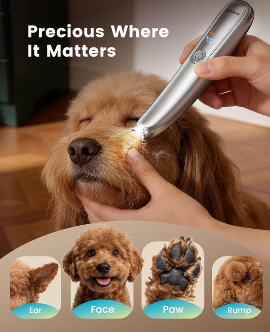 Silver pet hair clipper with built-in LED light illuminating dog paw pads.