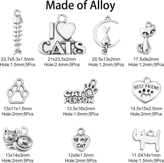 Variety of cat-themed Tibetan silver charms on a white background