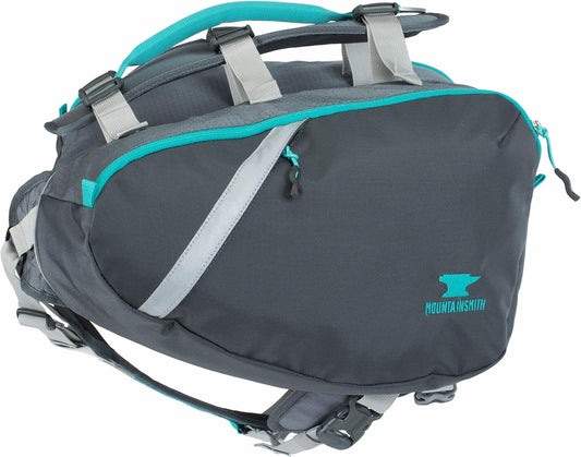 Side view of the Mountainsmith canine backpack showing the water-resistant zipper compartments and reflective trim panels.