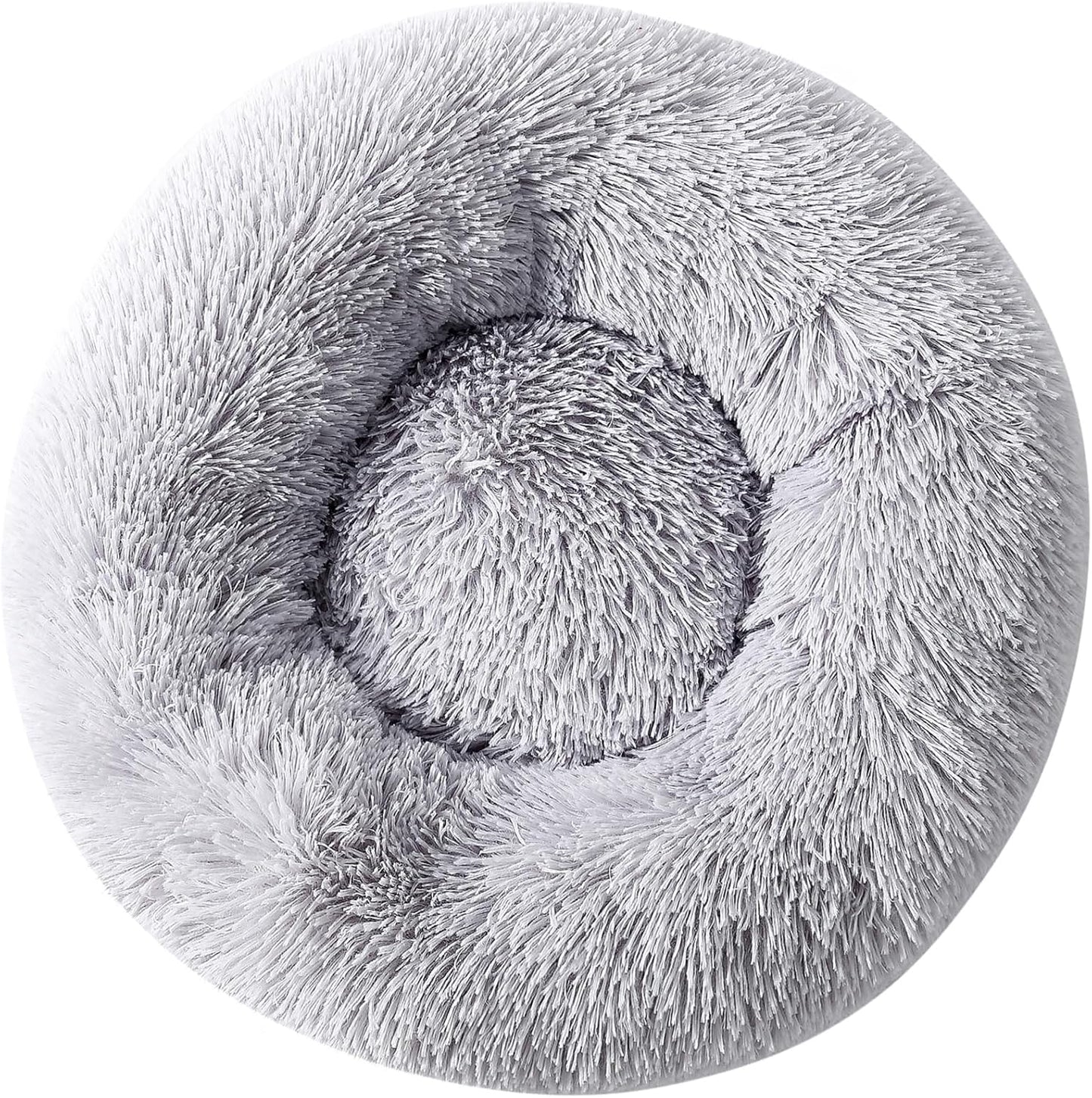 Top down view of small dog resting in circular donut bed