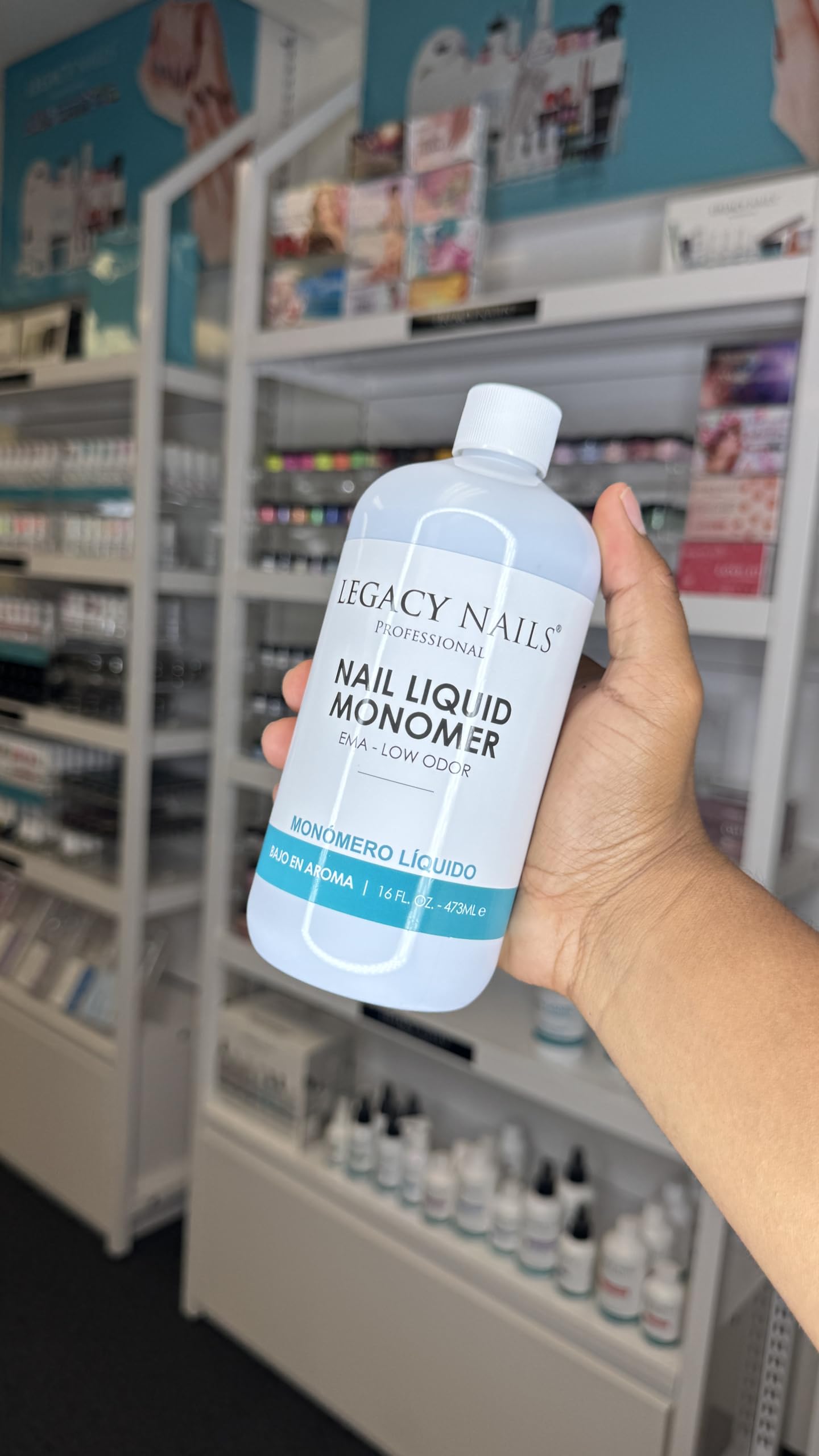 Legacy Nails professional monomer bottle showing fluid volume details for nail technicians.