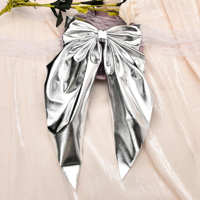 Model showcasing the dramatic long tail fluid drape of the silver metallic bowknot clip.