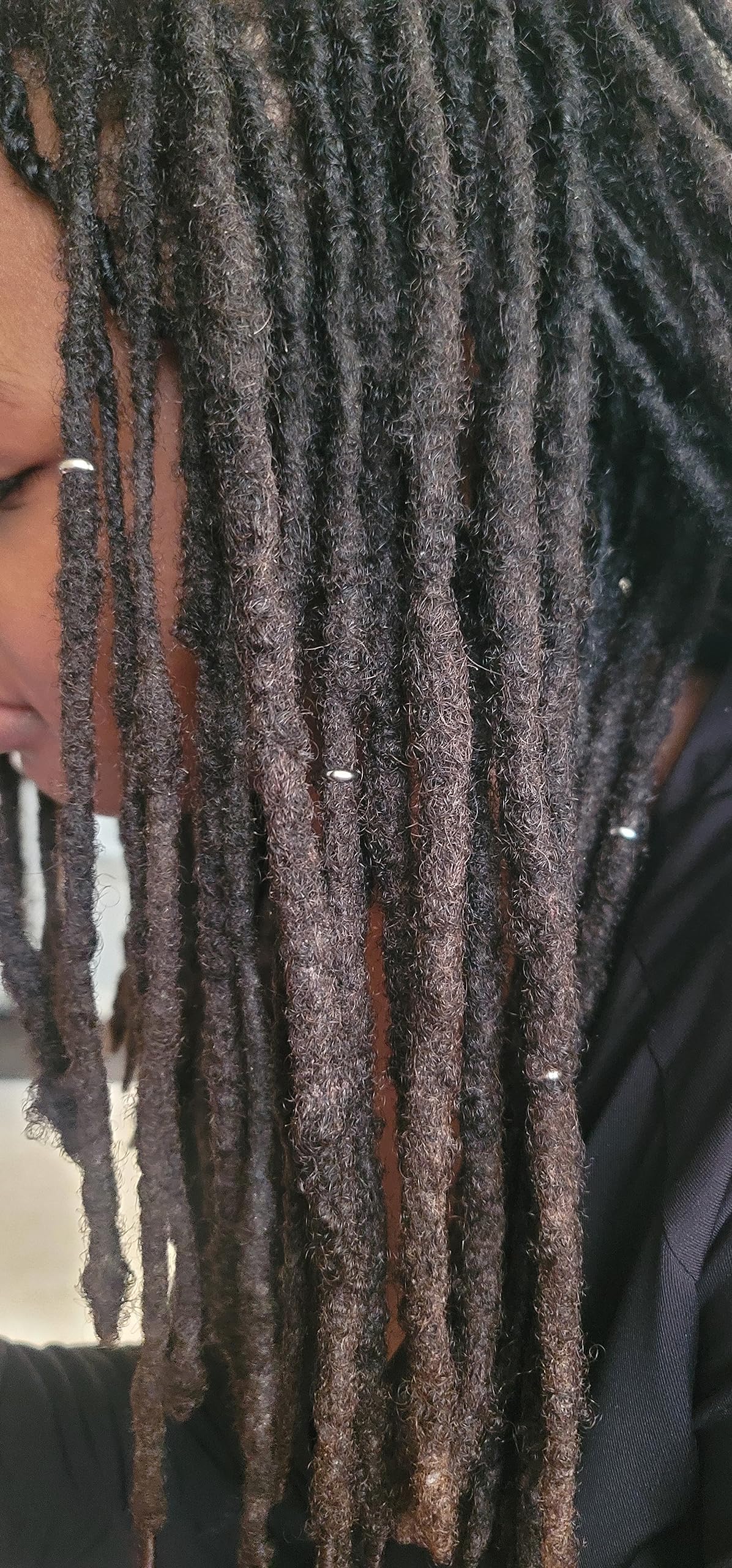 Side angle view of small five millimeter copper hair rings for lifestyle display