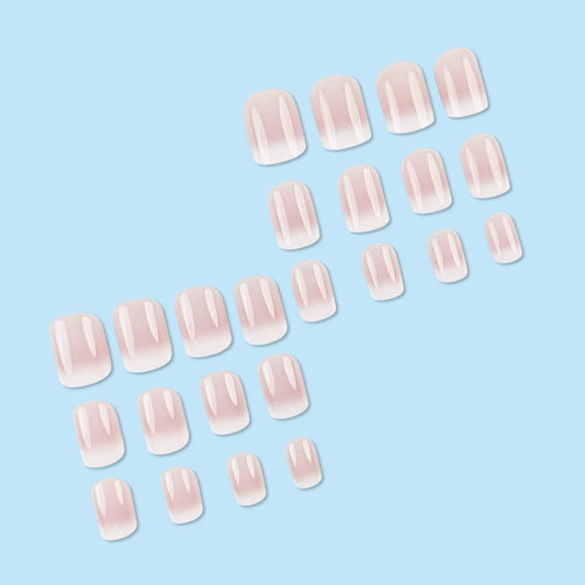 Close up of Juggssa French ombre glossy fake nails