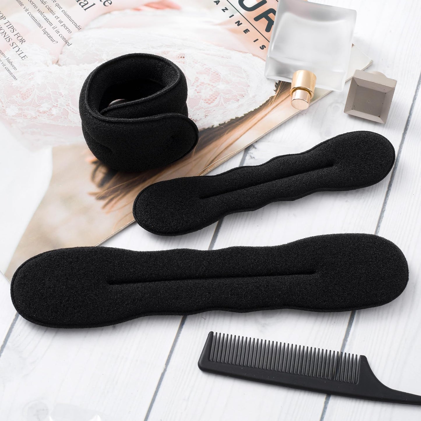 Three pieces of black hair donut bun makers in different sizes
