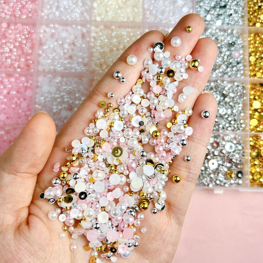 Close up of mix sizes flatback pearl nail art charms in grid container