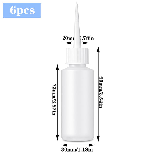 Six pieces of fifty milliliter clear needle tip bottles with protective red caps laid out flat