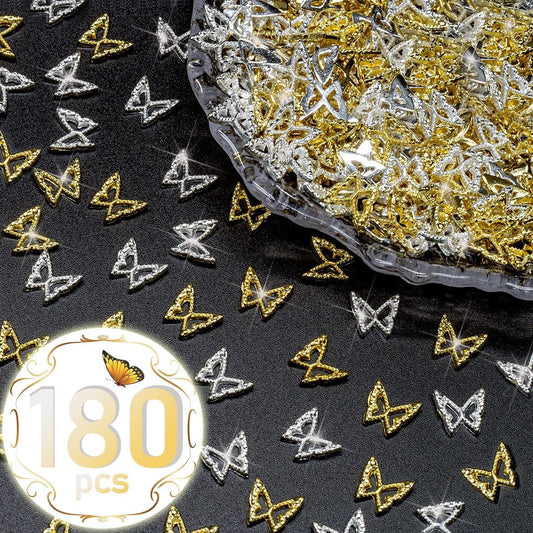 Close up view of golden butterfly alloy studs arranged neatly on an acrylic nail extension to showcase the intricate hollow out design.