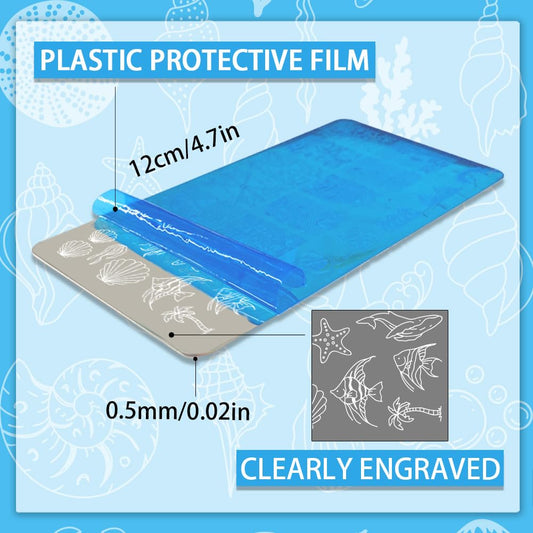 Stainless steel nail art templates featuring detailed mermaid and dolphin engravings close up view.