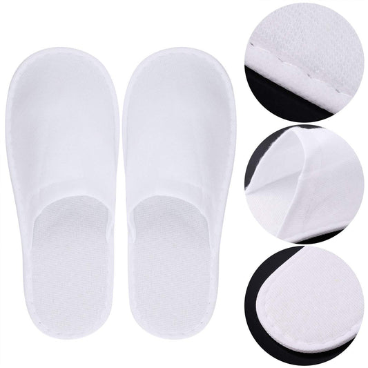 Side angle view of the twenty four pack hotel guest slippers displaying the thick non slip sole.