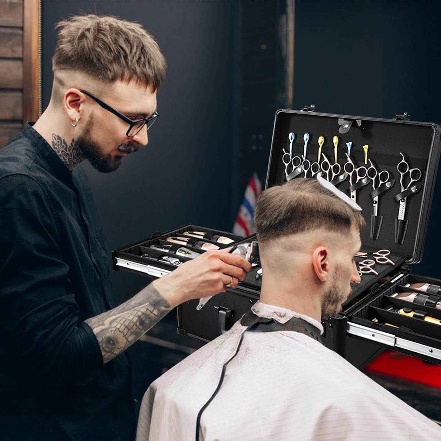 Yueieoun hair cutting supply case fully loaded with clippers, shears, and salon tools at a professional workstation.