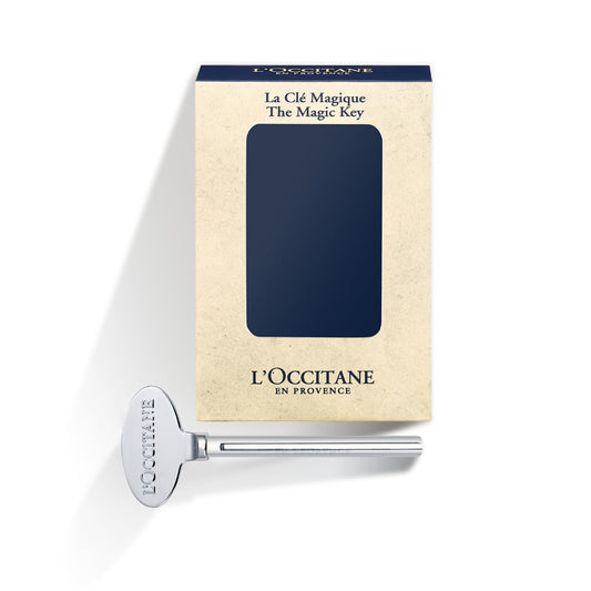 Close up of L'Occitane Magic Key attached to a hand cream tube.