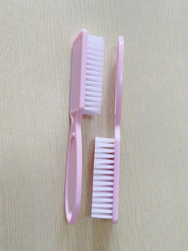 Hygienic pink toenail scrubbing brushes hanging on a hook for drying