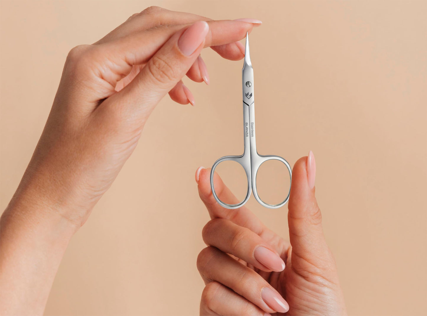 Compact travel size beauty scissors in an elegant protective pouch package.