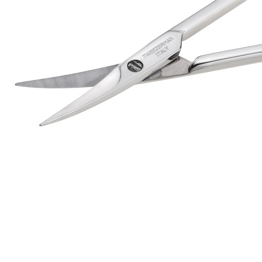 Close up angle of Tweezerman stainless steel cuticle nail scissors emphasizing the ultra fine sharp blades