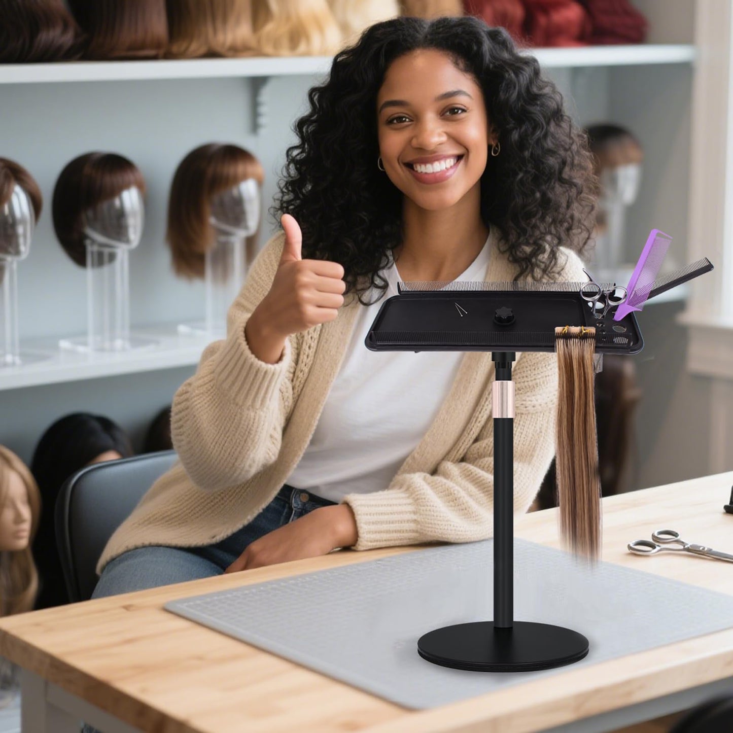 Freestanding hair extension hanger setup in a modern barber shop workspace.