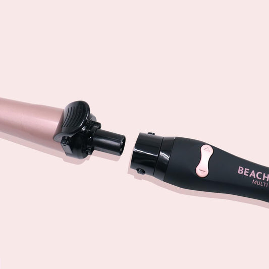 Professional automatic rotating hair curler by The Beachwaver Co with three styling attachments and arrow control buttons