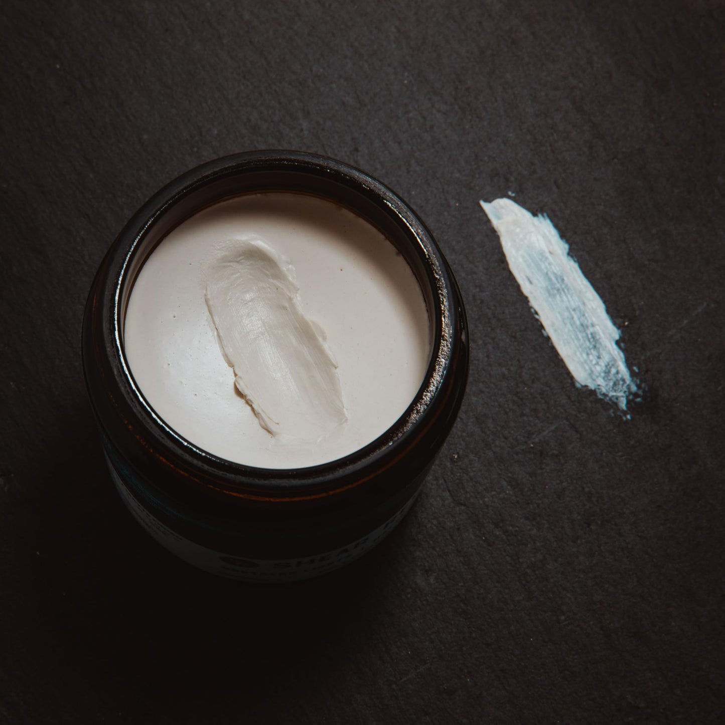 Shear Revival travel friendly hair paste container highlighting the citrus and sage scent formulation