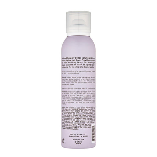 Hairitage texturizing hair spray bottle displaying ingredients list including rice protein and sunflower seed oil.