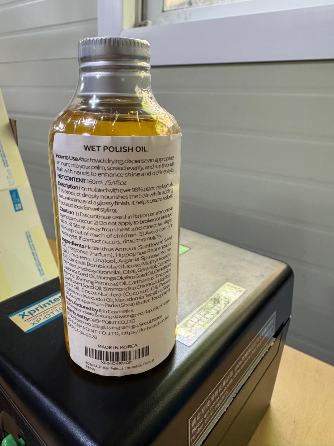 Forbeaut Wet Hair Polish Oil 160ml bottle unboxed on a reflective surface.