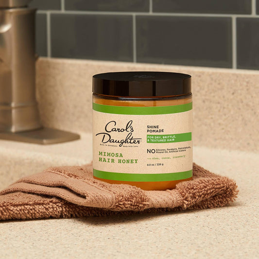 Carol's Daughter textured hair pomade showing citrus and shea butter ingredients