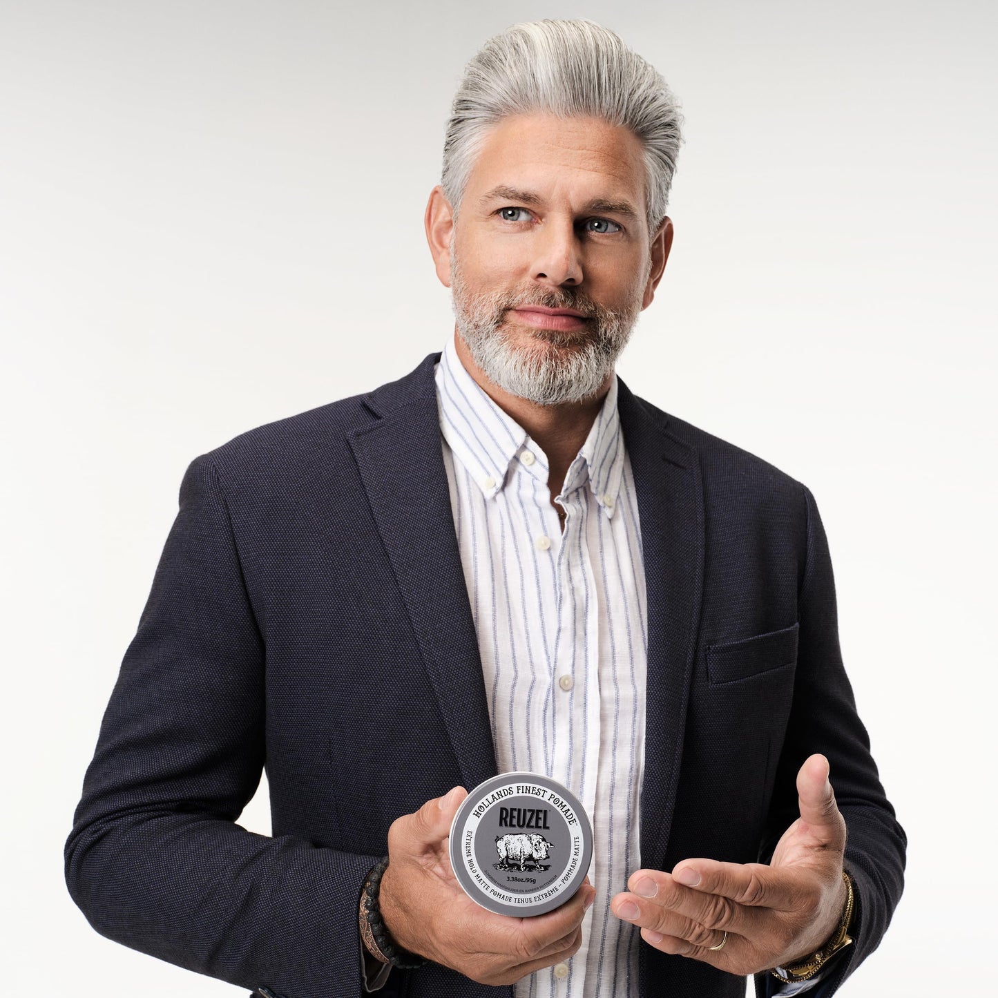 Strongest hold styling pomade tin back view with complete ingredients list.