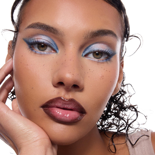 Uncapped long-lasting fake freckles makeup pen demonstrating the flexible tip designed for custom dotting.