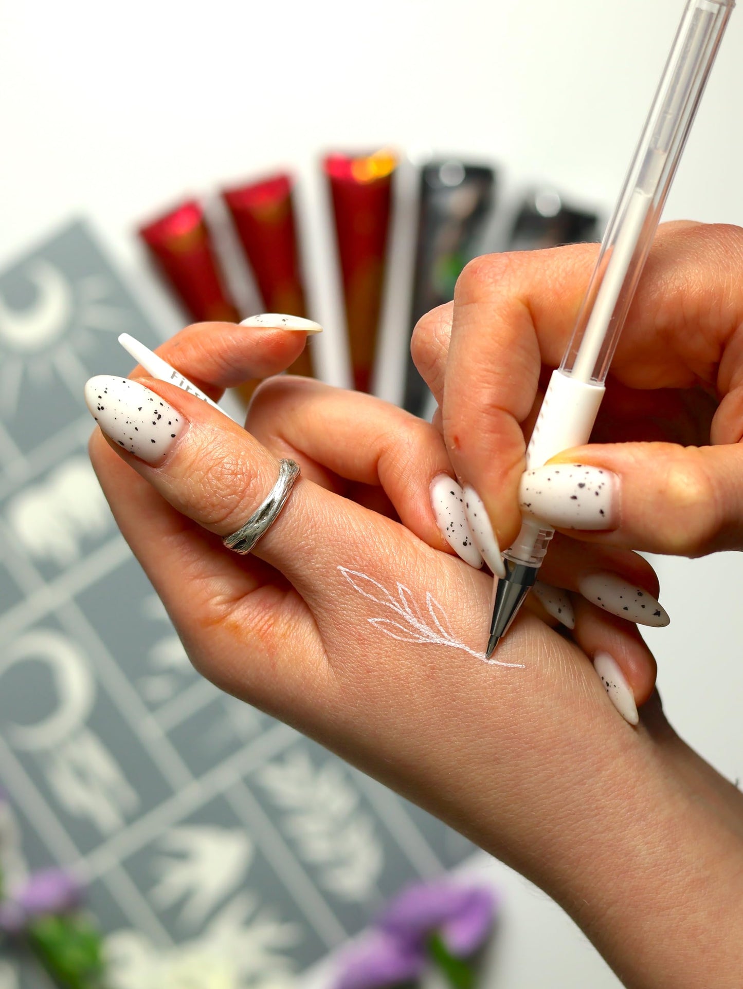 Close up of the fine tip on the white erasable marker pen for clear skin design placement