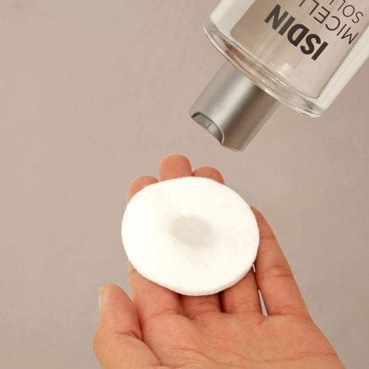 ISDIN 4-in-1 makeup remover and hydrating toner bottle showing clear liquid solution