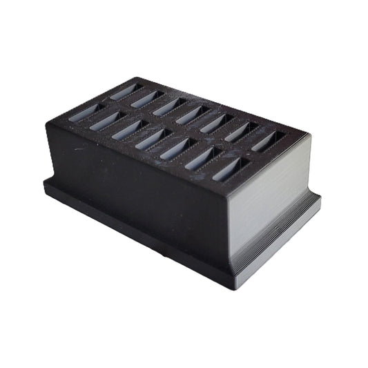 Compact black 3D printed eye drop storage tray placed on a clean counter space