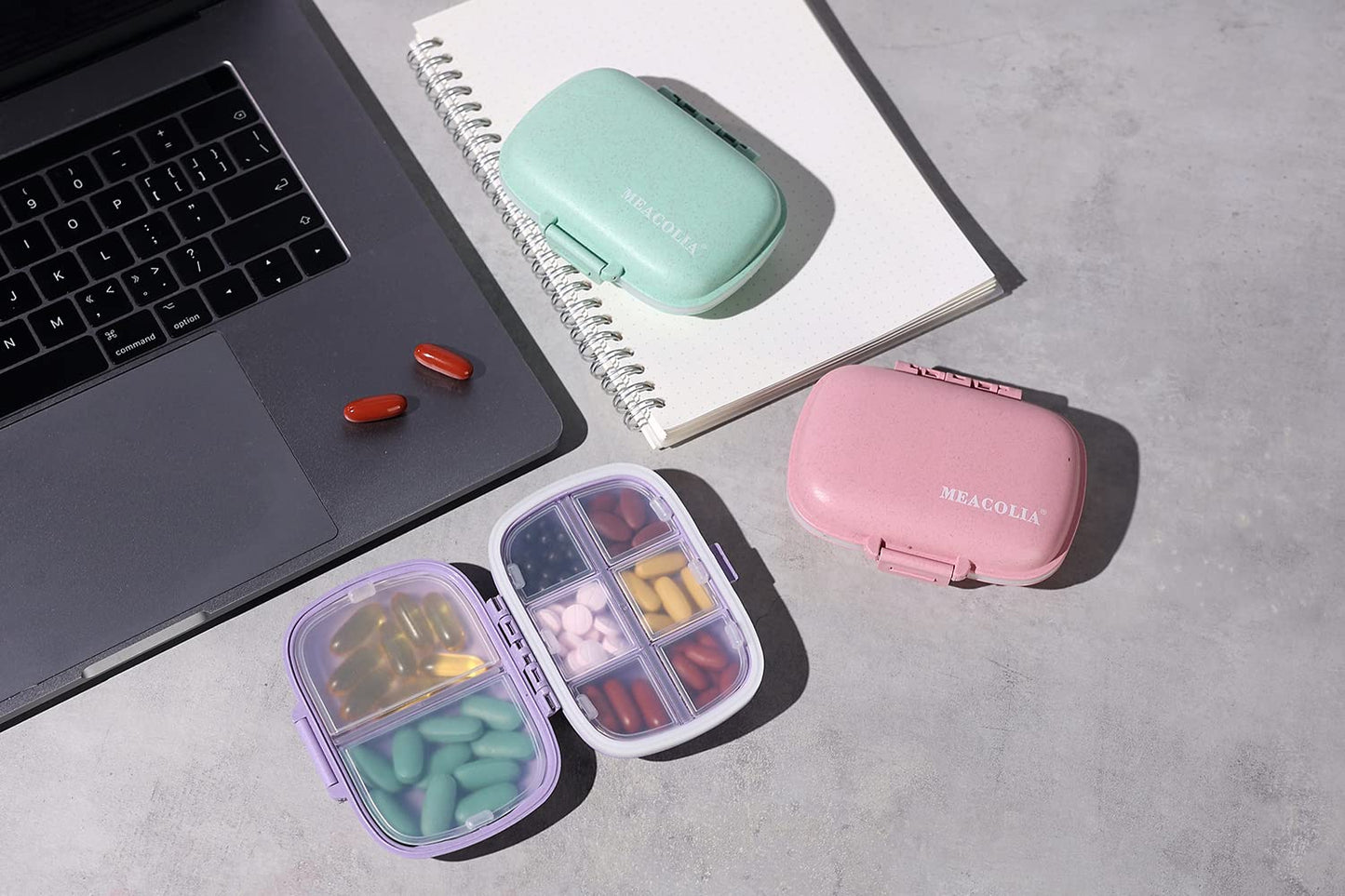 Meacolia three pack multi color daily pill organizers stacked together for travel planning