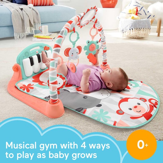Newborn baby using Fisher-Price piano gym for tummy time