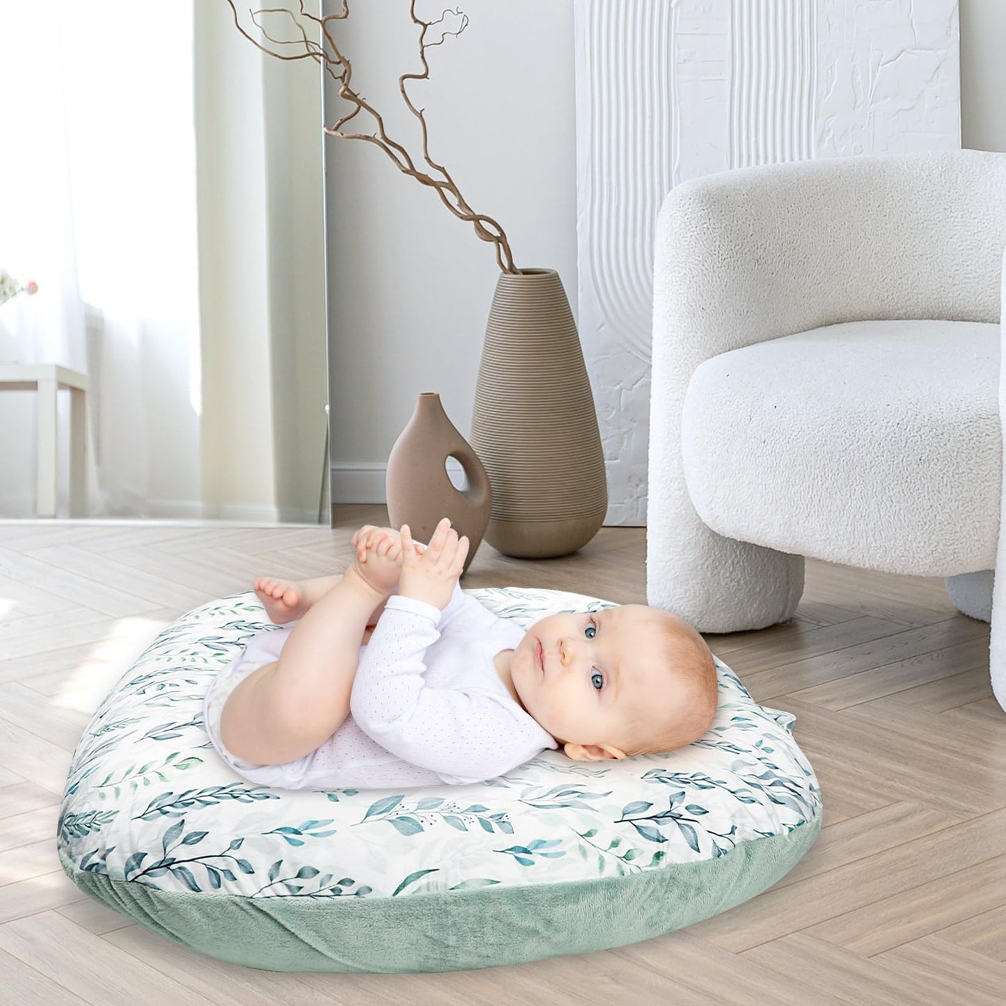 Lifestyle shot of baby lounger with decorative green leaf cover