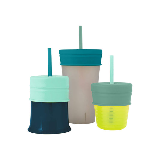 Universal silicone straw sippy cup lids by Boon stretched securely over a standard toddler drinking cup to prevent spills