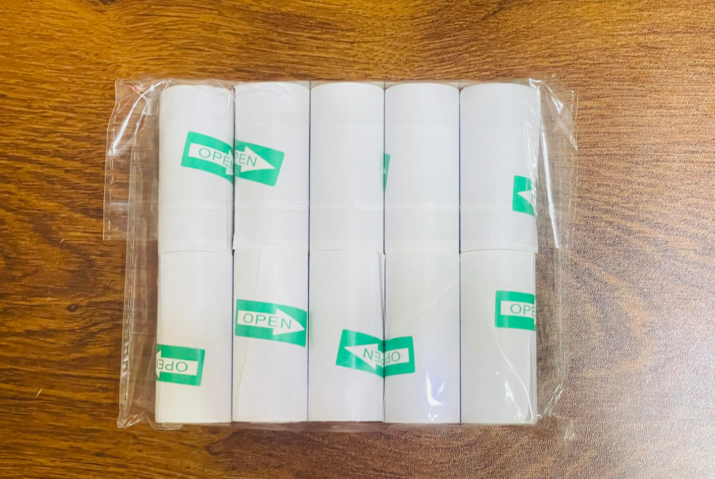 Cilser replacement paper rolls being loaded into a portable mini handheld pocket printer.