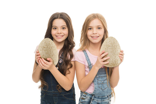 Children using the mallet and chisel tools to dig into the seven inch plaster dinosaur egg.